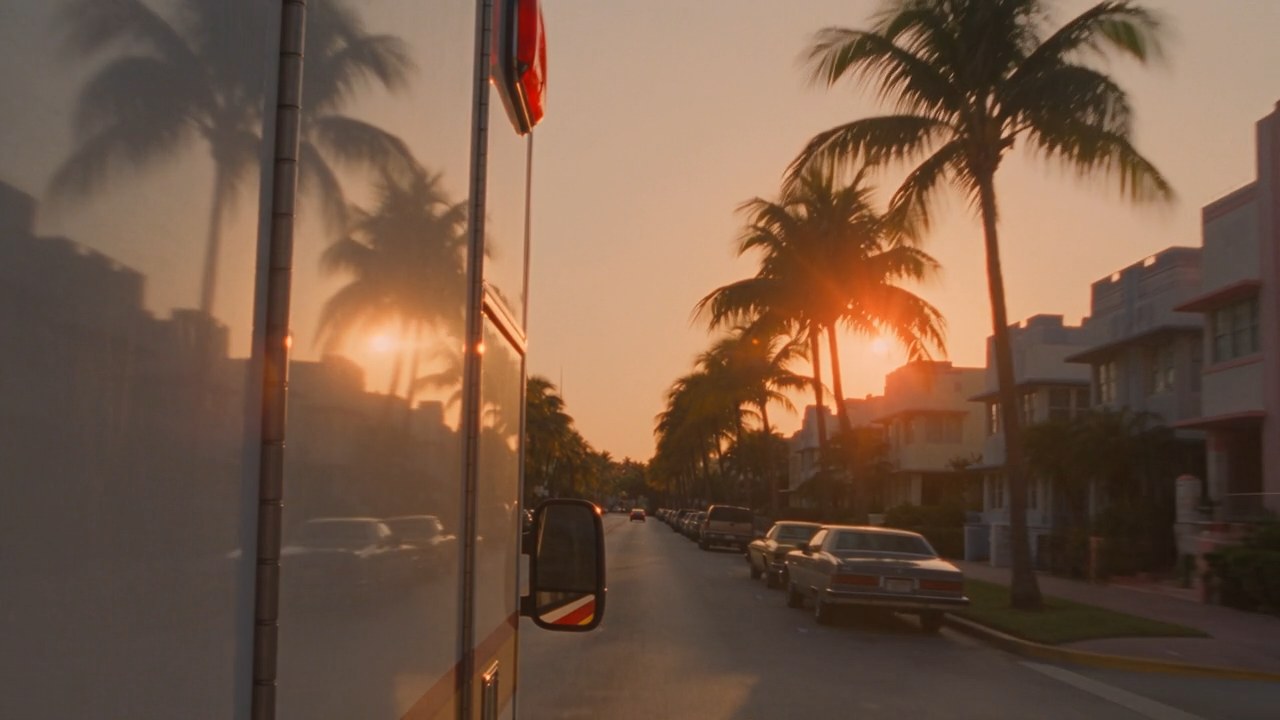 Un'ambulanza che sfreccia fra le palme di Miami al tramonto